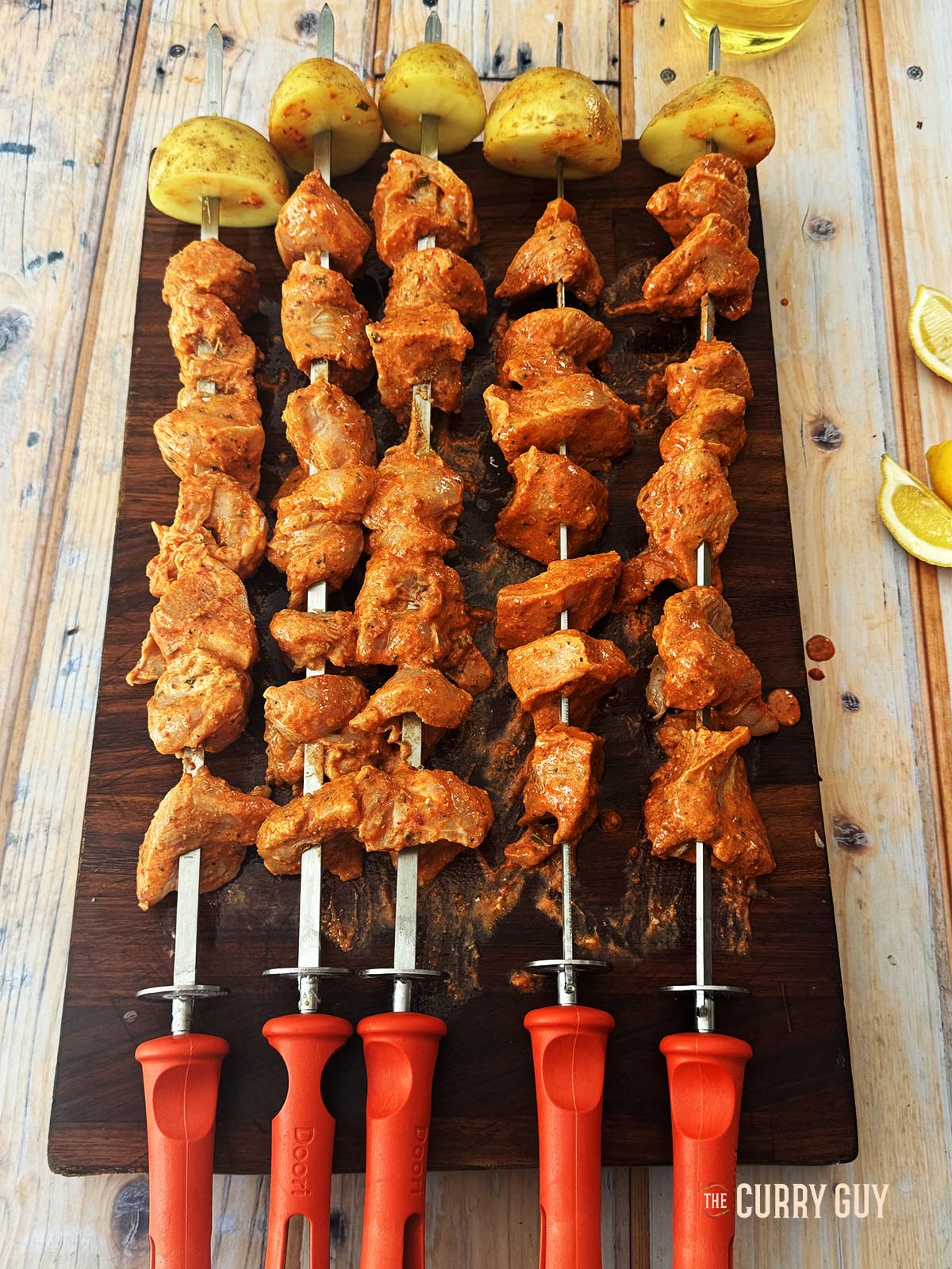 The marinated chicken on skewers, ready to cook. 
