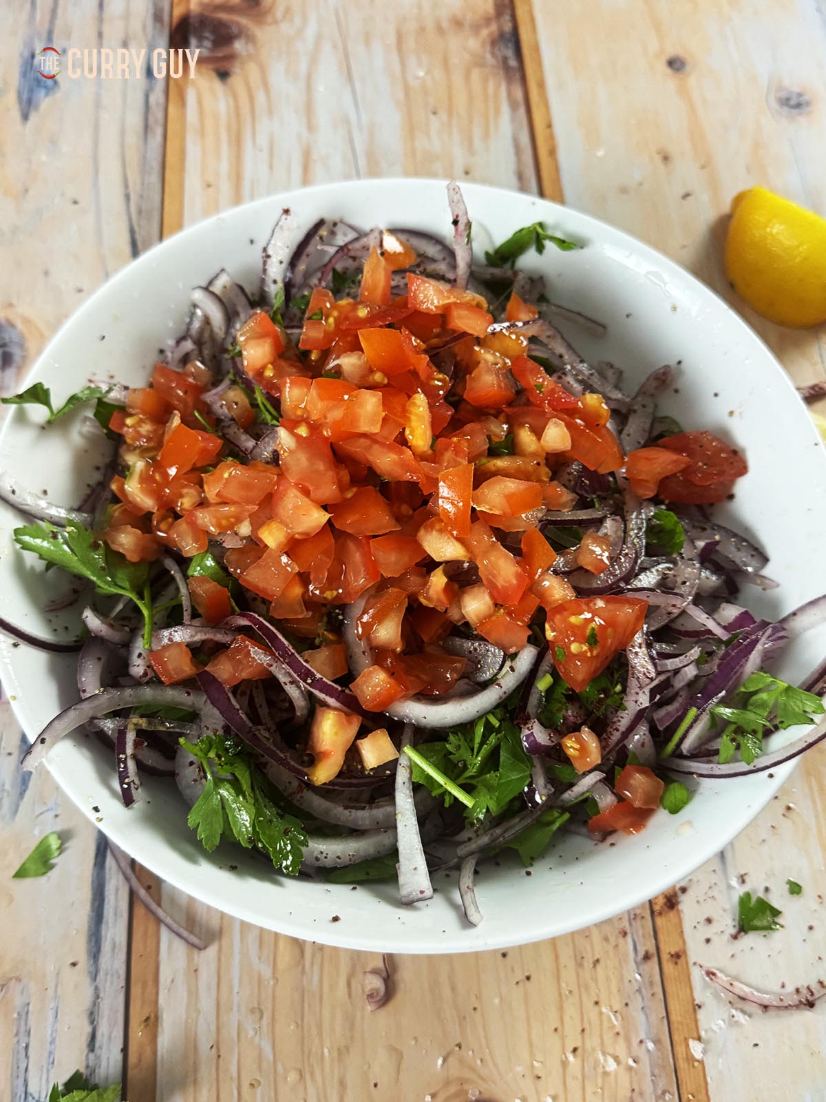 The salad topped with tomatoes. 