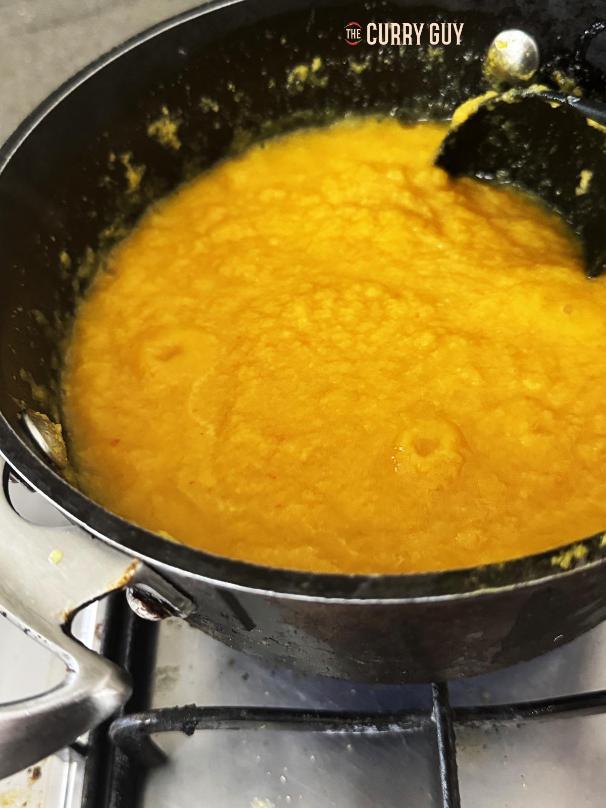 Bringing the sauce to a simmer.