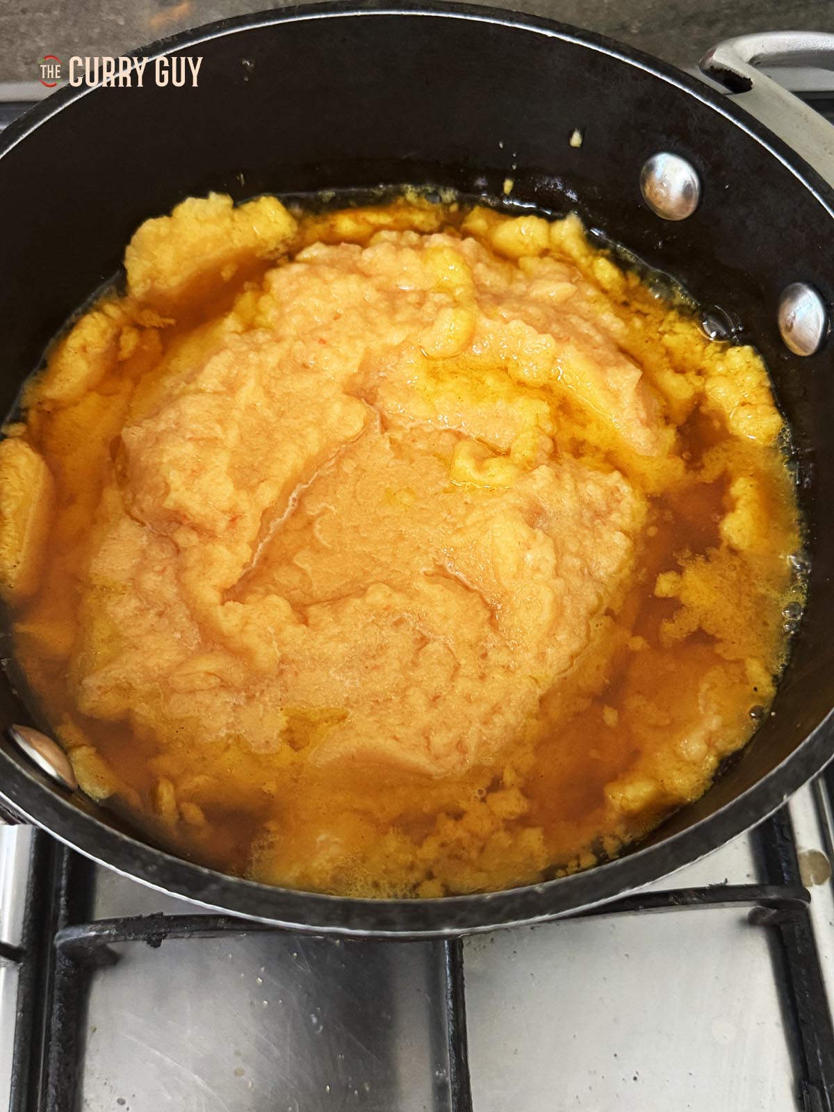 Pouring the blended onion mixture into the pot.