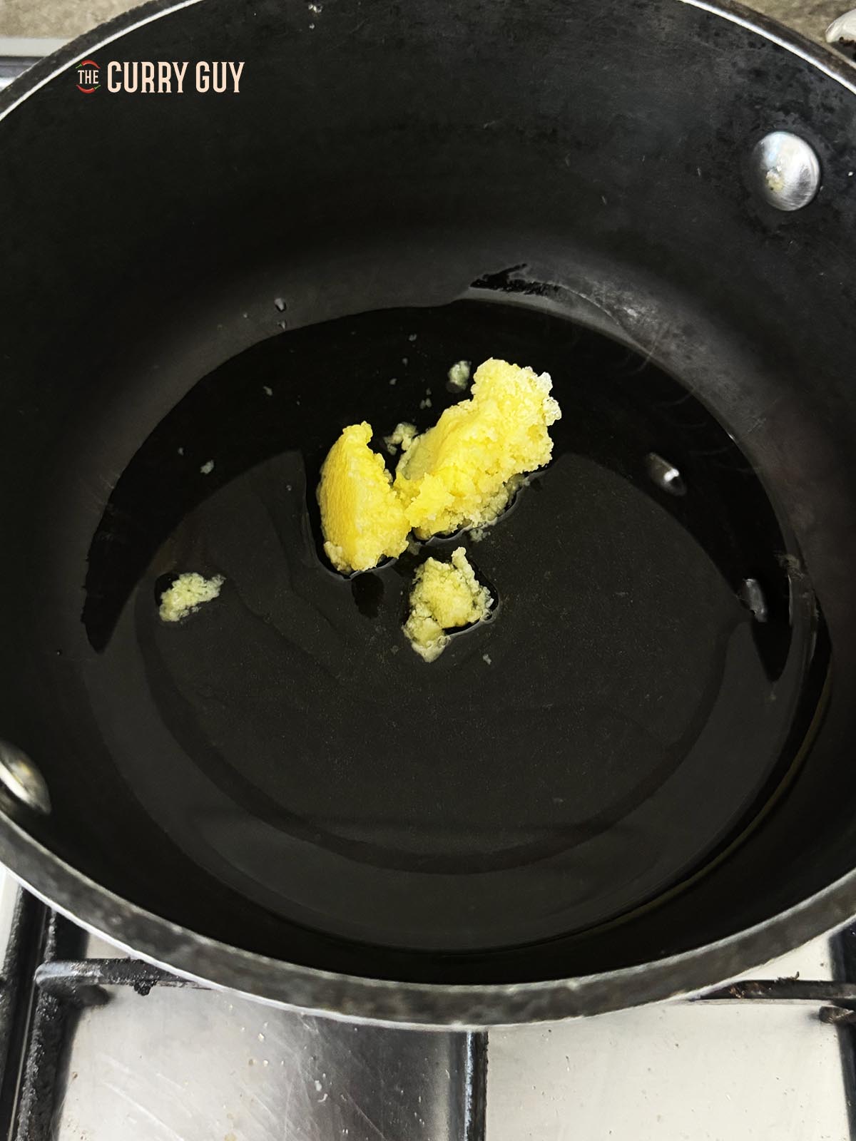 Melting the ghee in a pan.