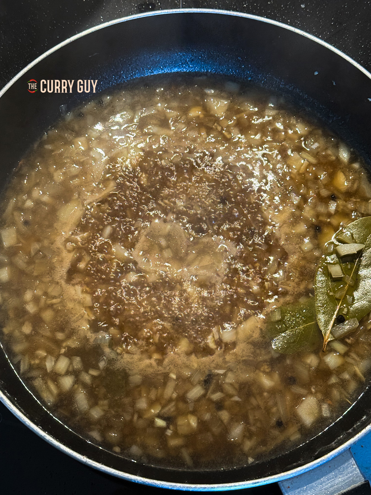 liquid ingredients added to the pan for the chicken adobo recipe