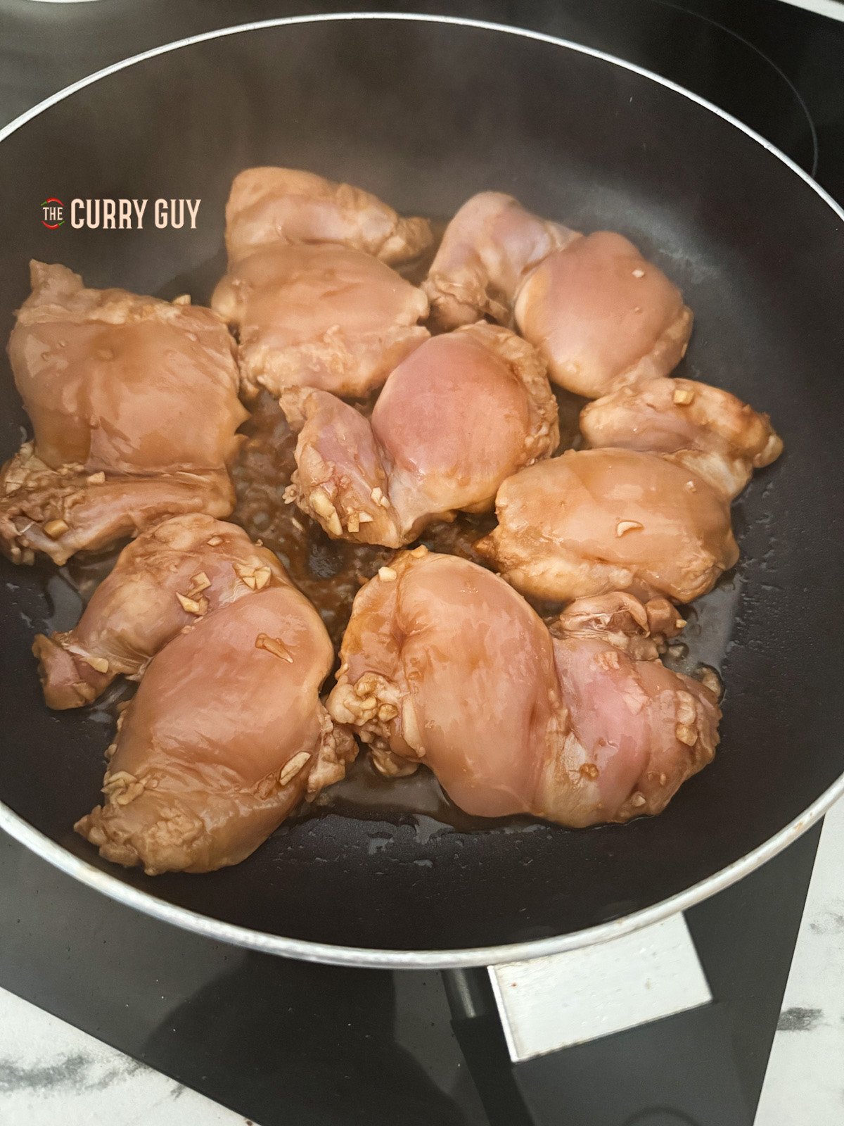 searing the chicken in the pan. 