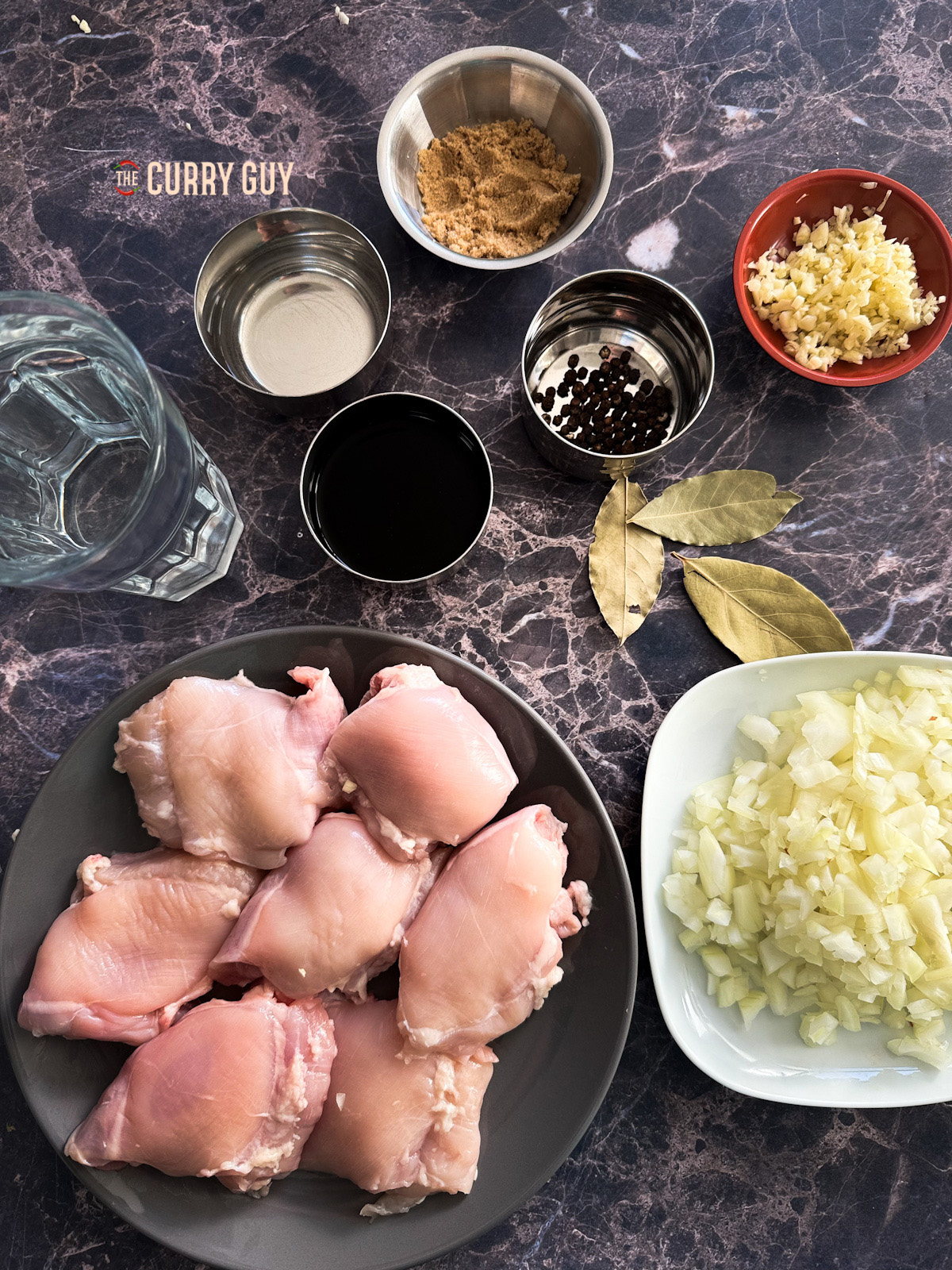 ingredients portioned in bowls for chicken adobo. 