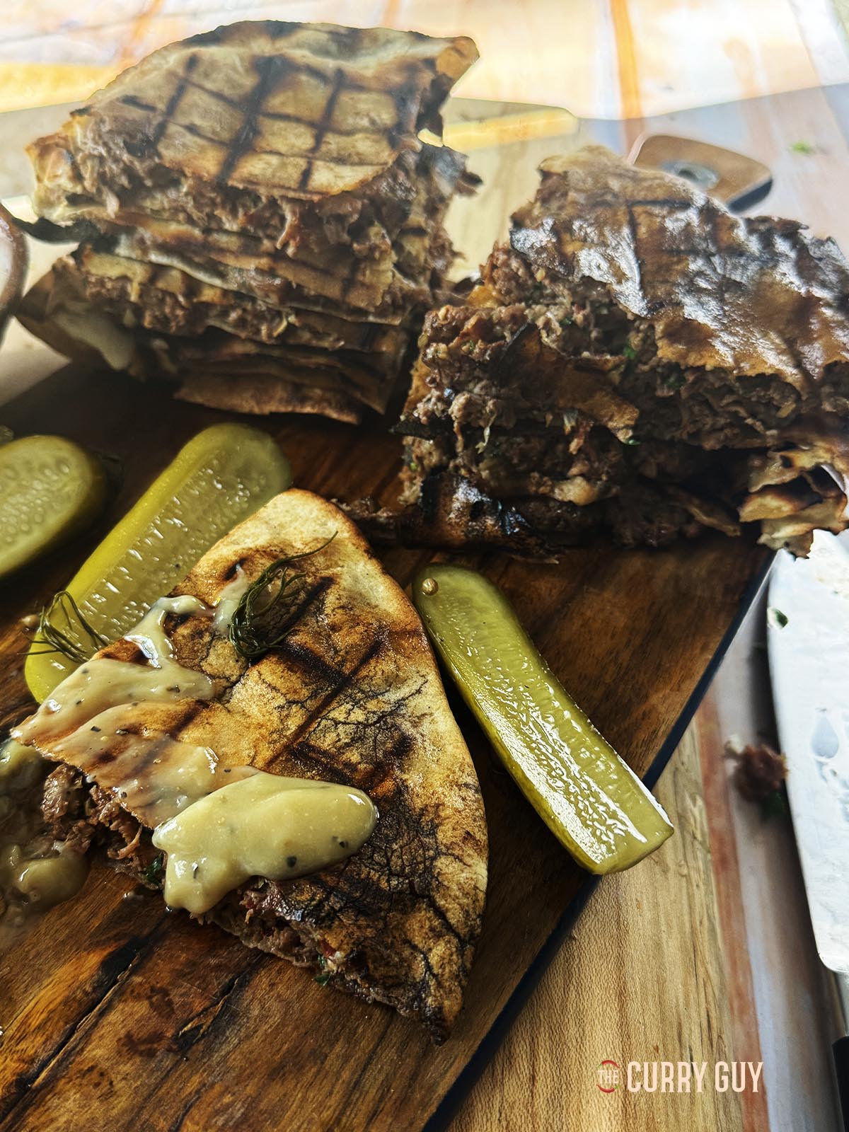 Areyes, meat stuffed pitas on a serving platter. 