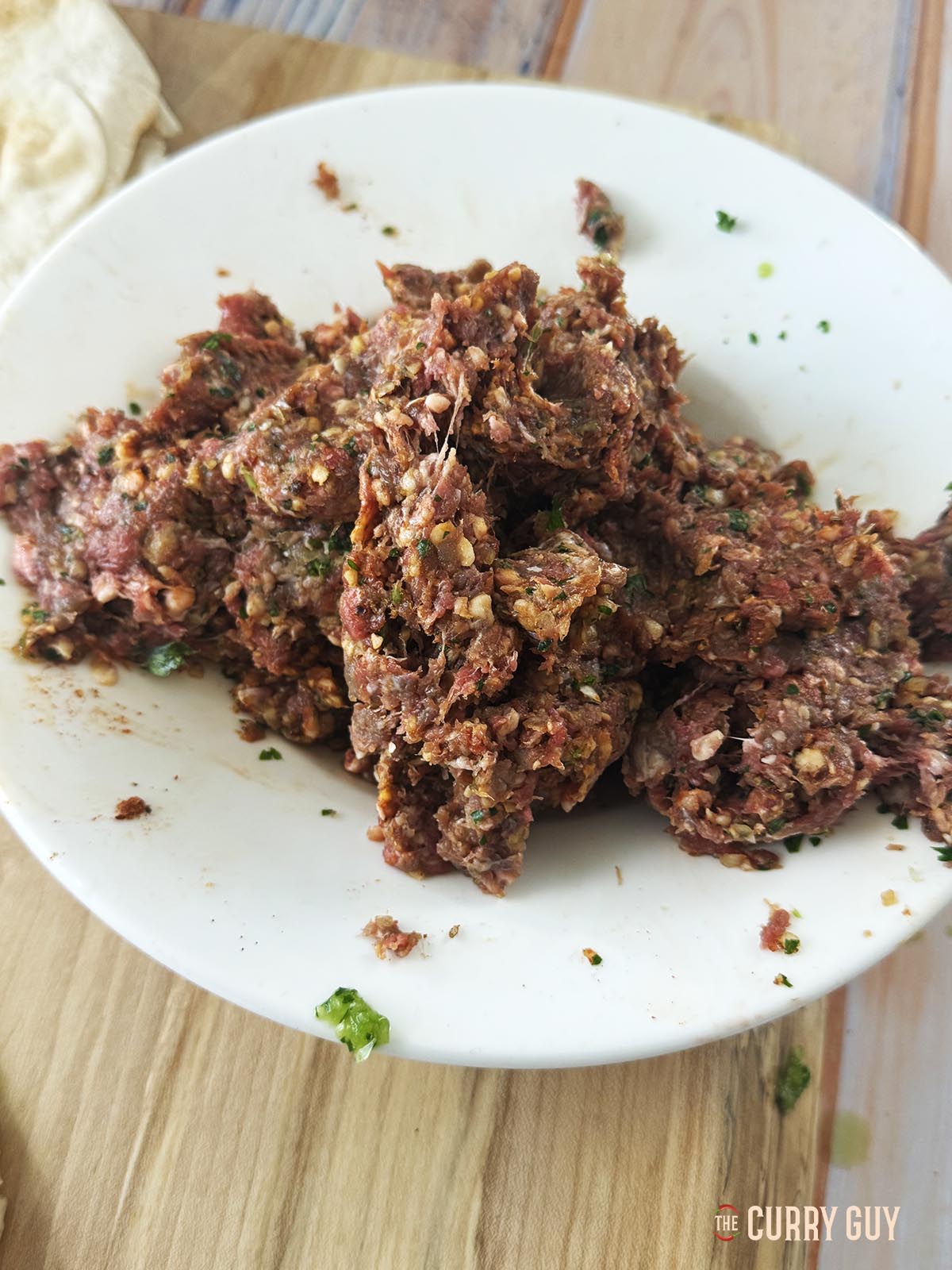 The meat mixture with the spices, parsley, garlic and onion.