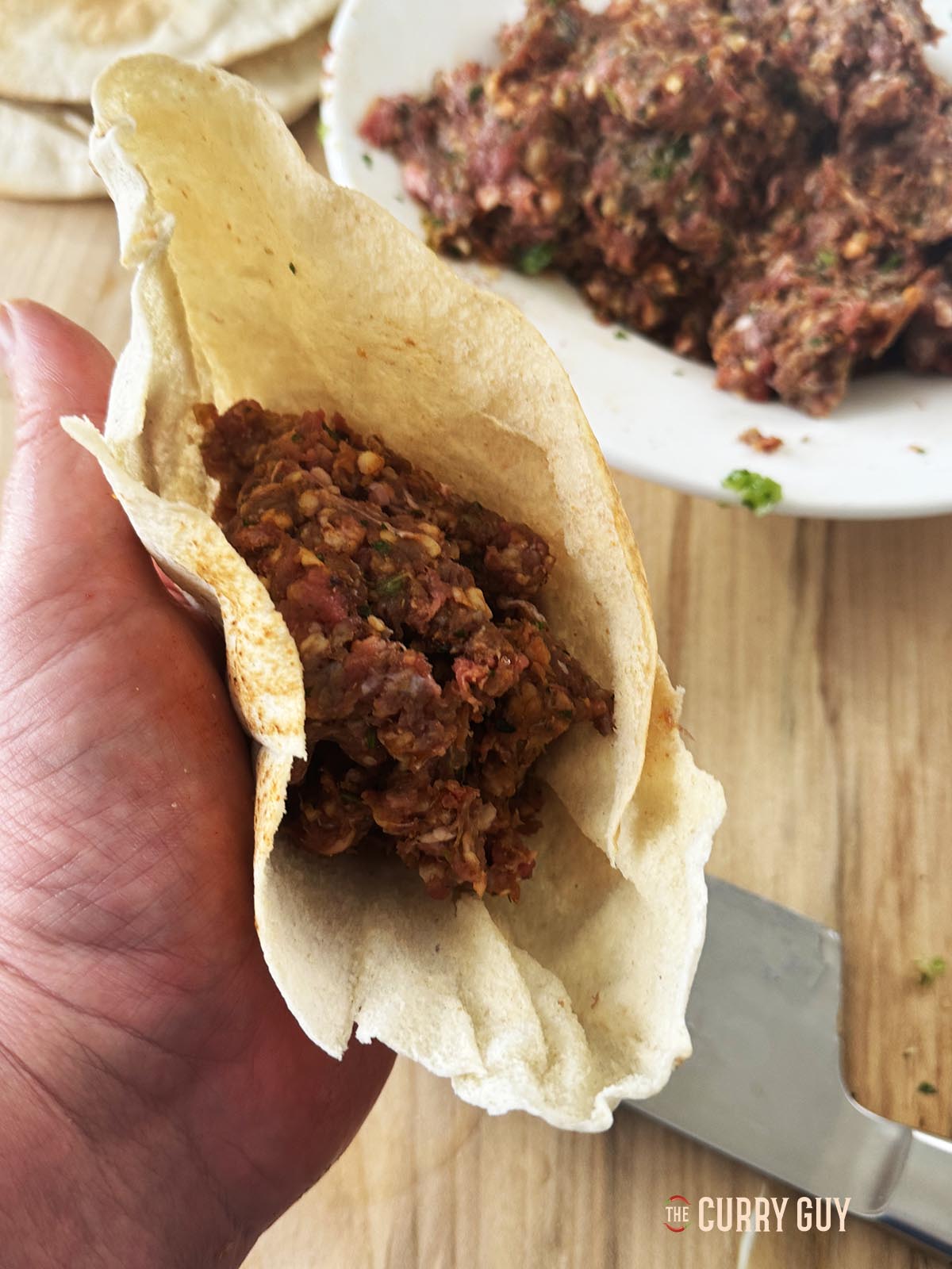 Filling the pitas with the meat mixture.