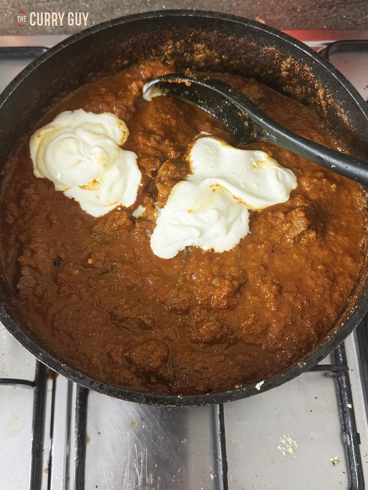 Cooking the curry down and adding the yoghurt.