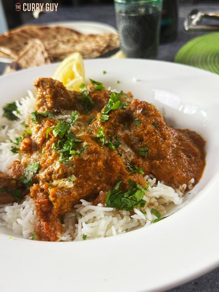 The beef tikka masala served over rice and garnished with chopped coriander.