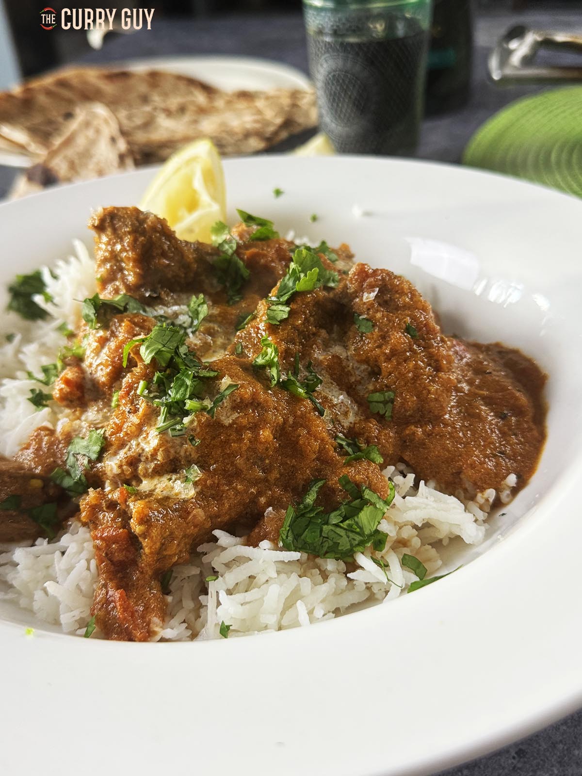 The beef tikka masala served over rice and garnished with chopped coriander. 