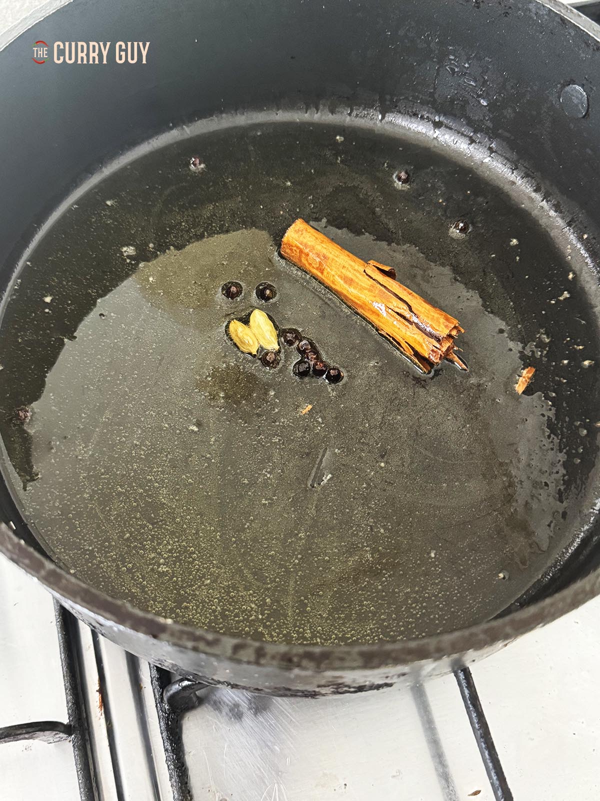 Infusing the spices into the oil and ghee over a medium heat.