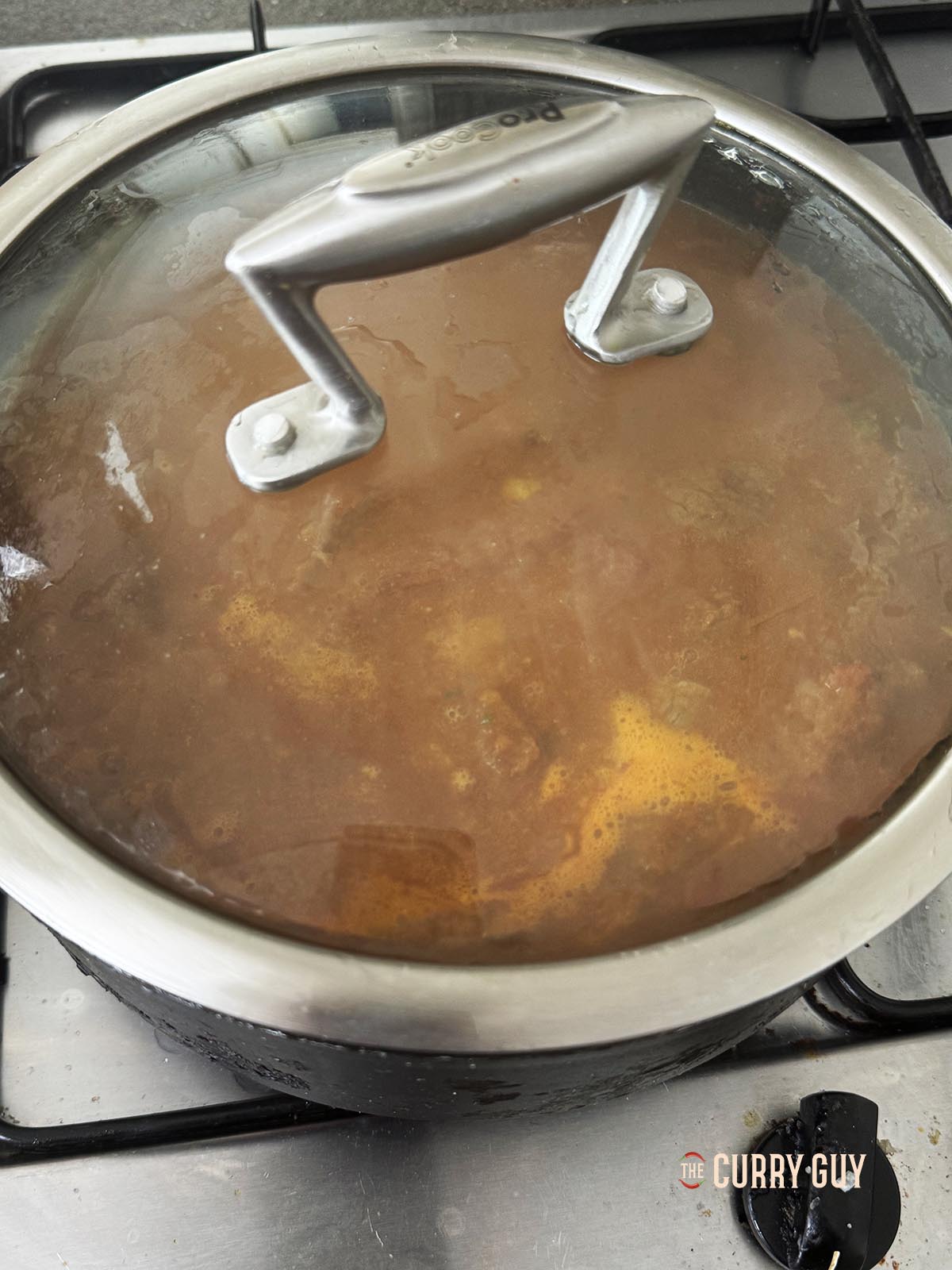 Covering the pan to simmer until the beef is tender.