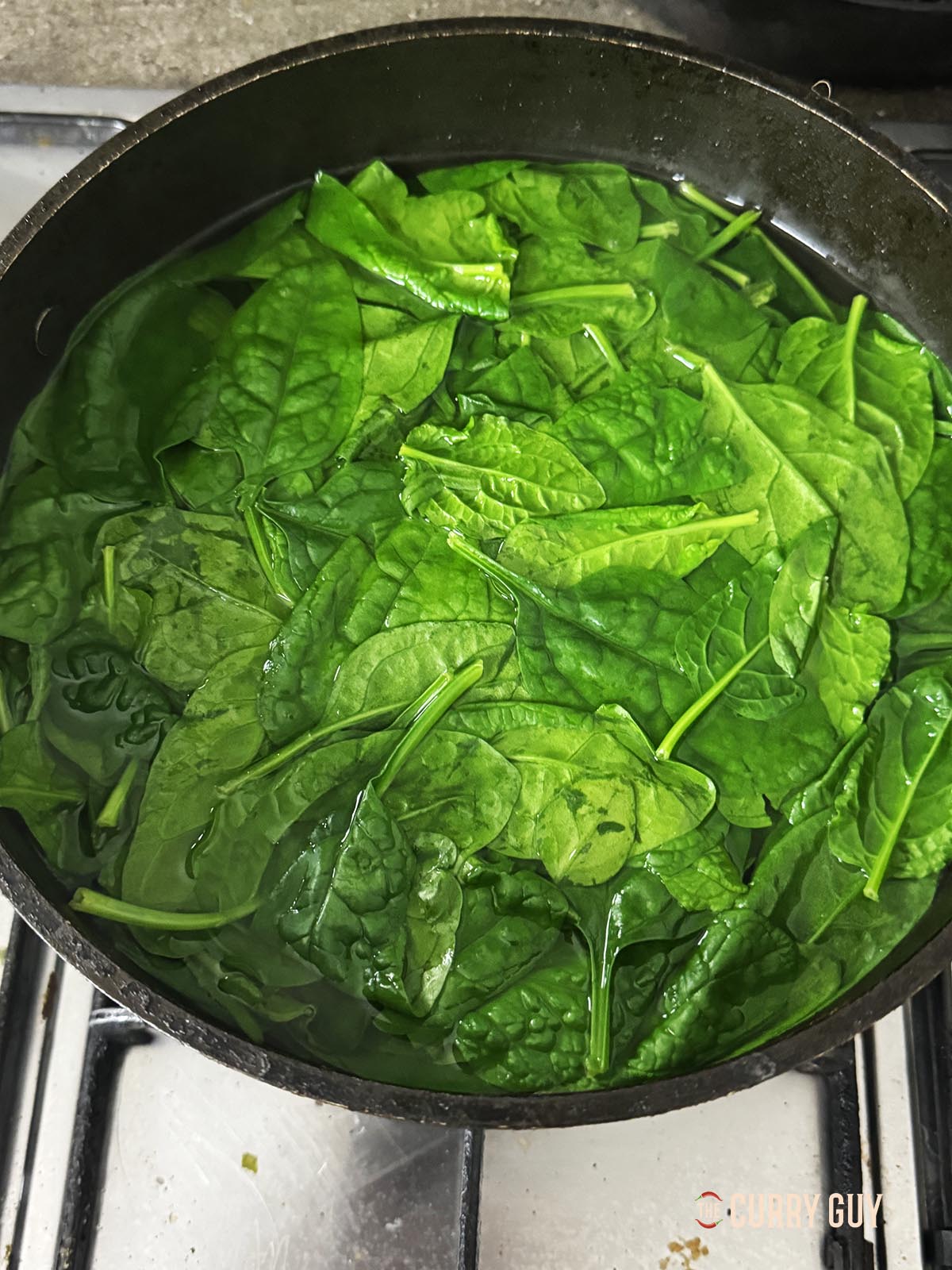 Cooking the spinach in boiling water.