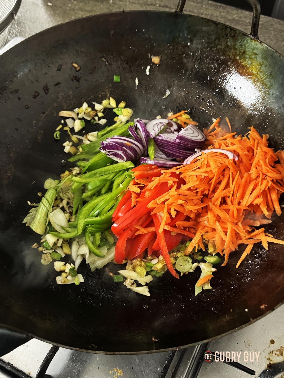 Frying the vegetables in the wok.