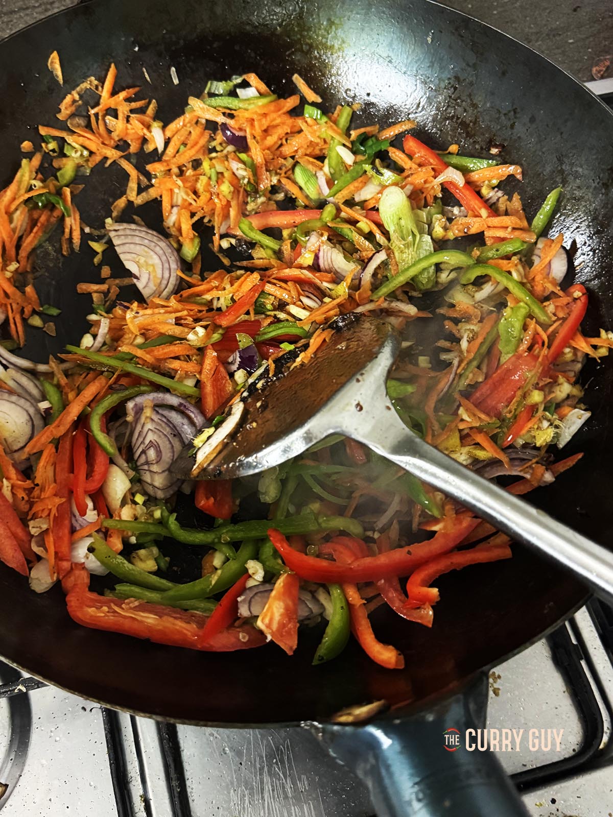 Frying the vegetables in the wok.