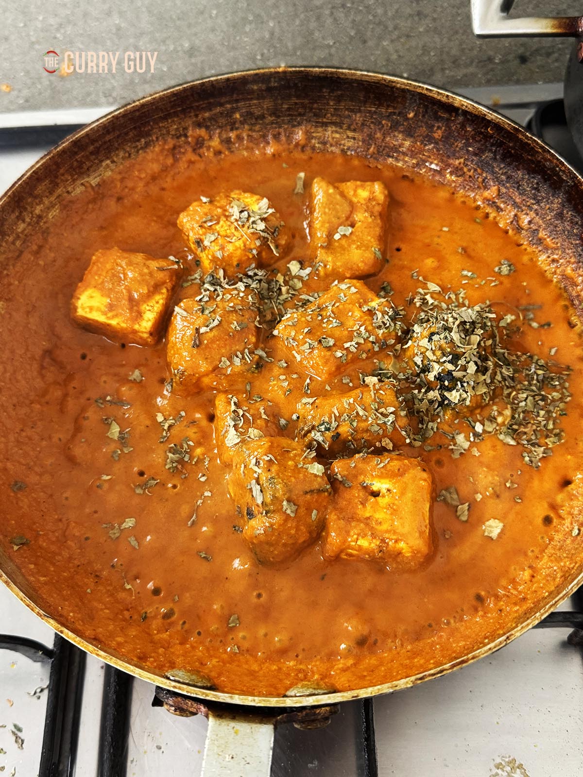 Adding the kasoori methi to the pan.