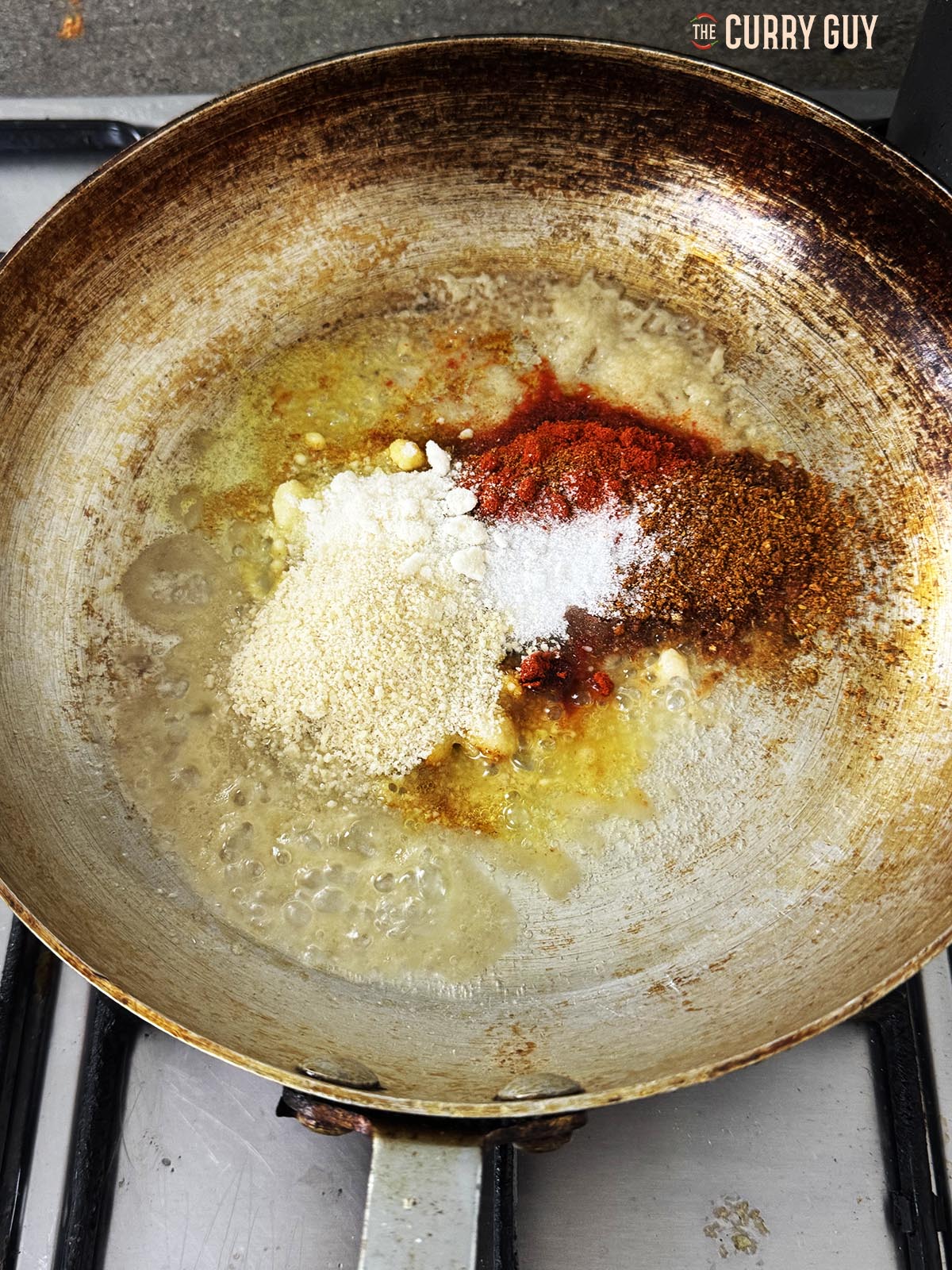 Stirring in the ground spices, coconut, sugar and ground almonds.
