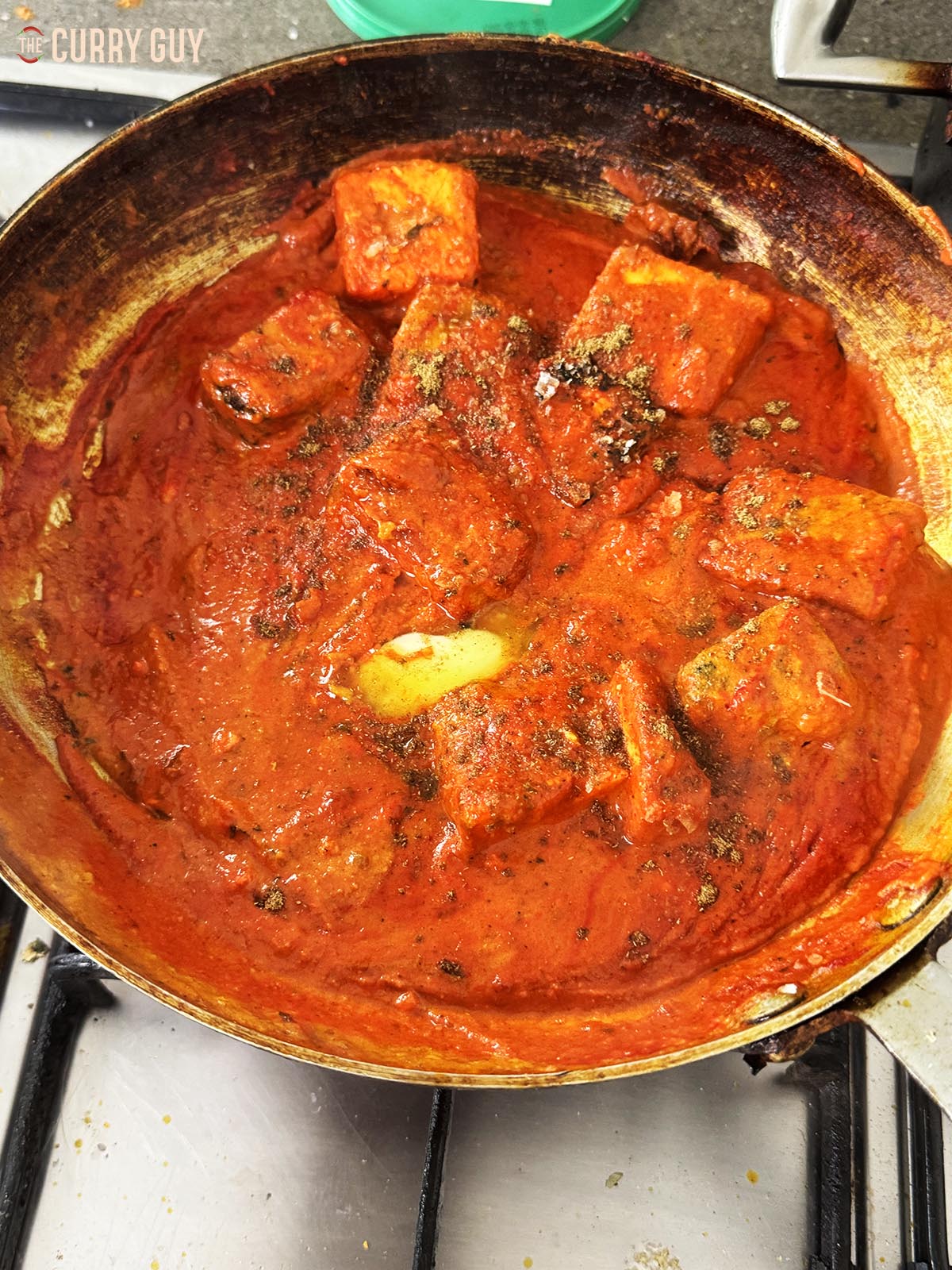 Adding the butter to the sauce.