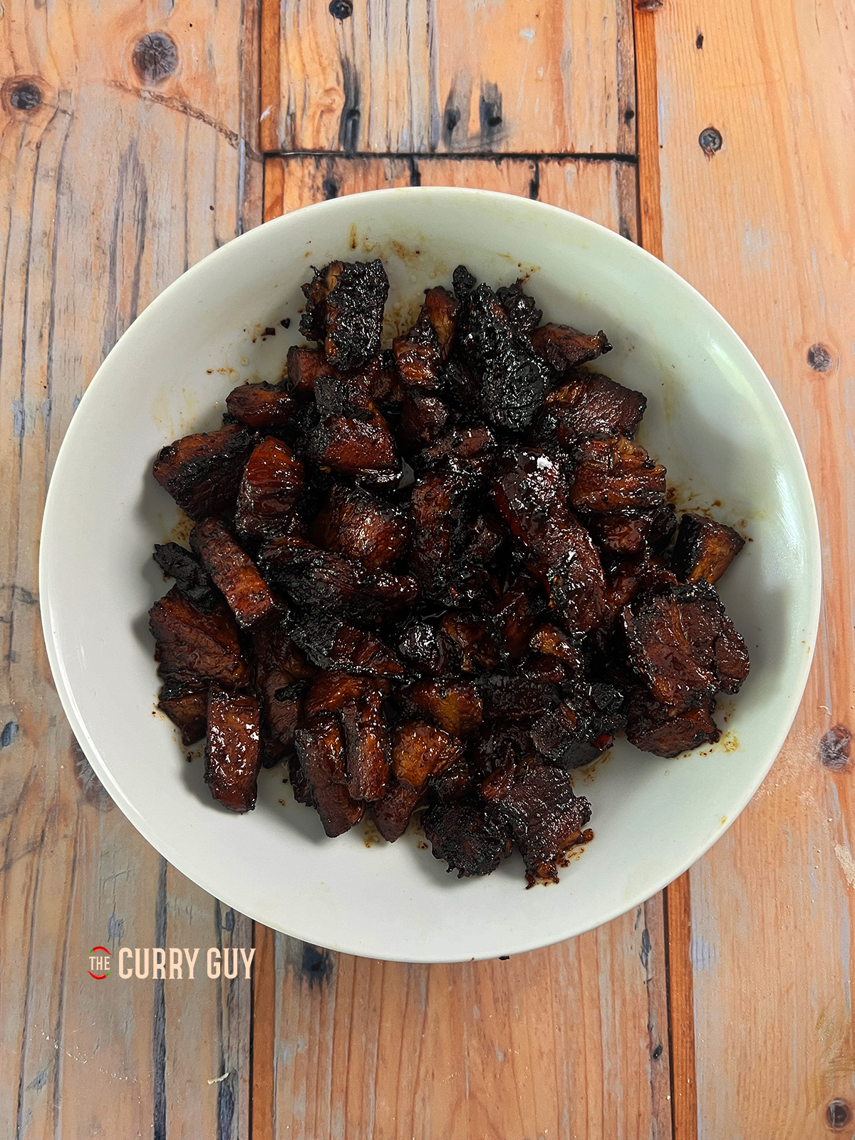 sticky pork belly in a bowl ready for bao