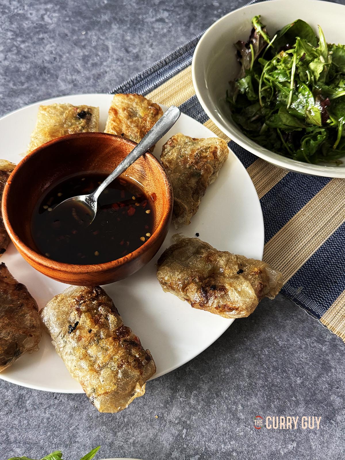 The rice paper dumplings on a serving dish with the dipping sauce.