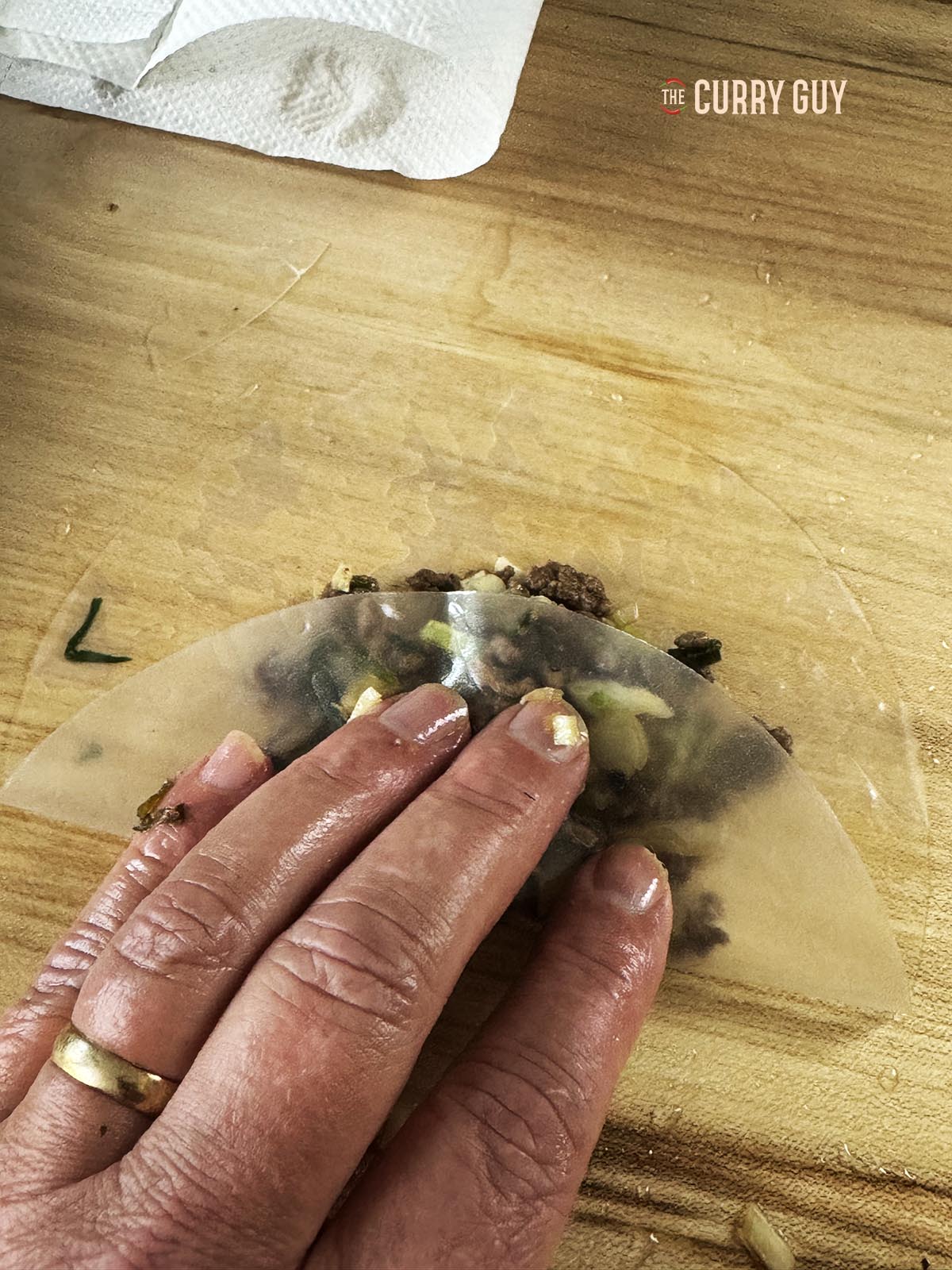 Folding the rice paper over the meat.