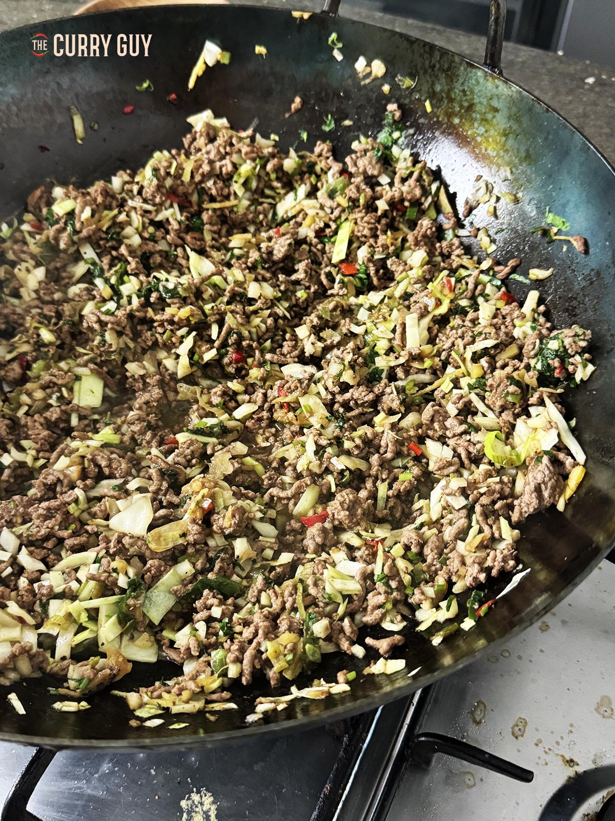 The cooked meat and vegetable mixture in the wok.