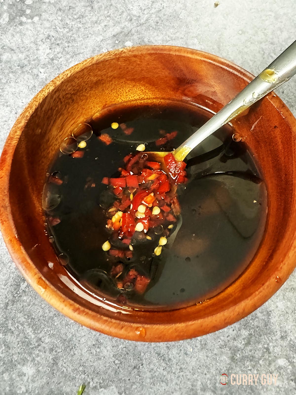 Whisking the dipping sauce ingredients together in a bowl.