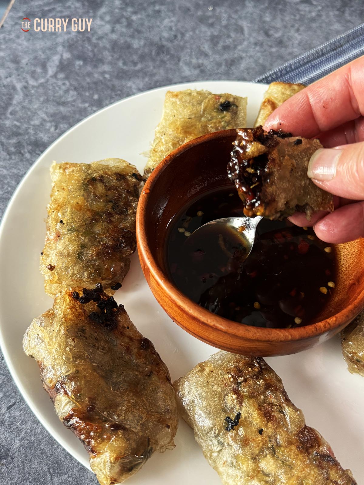 Rice paper dumplings. Dipping a dumpling into the dipping sauce.