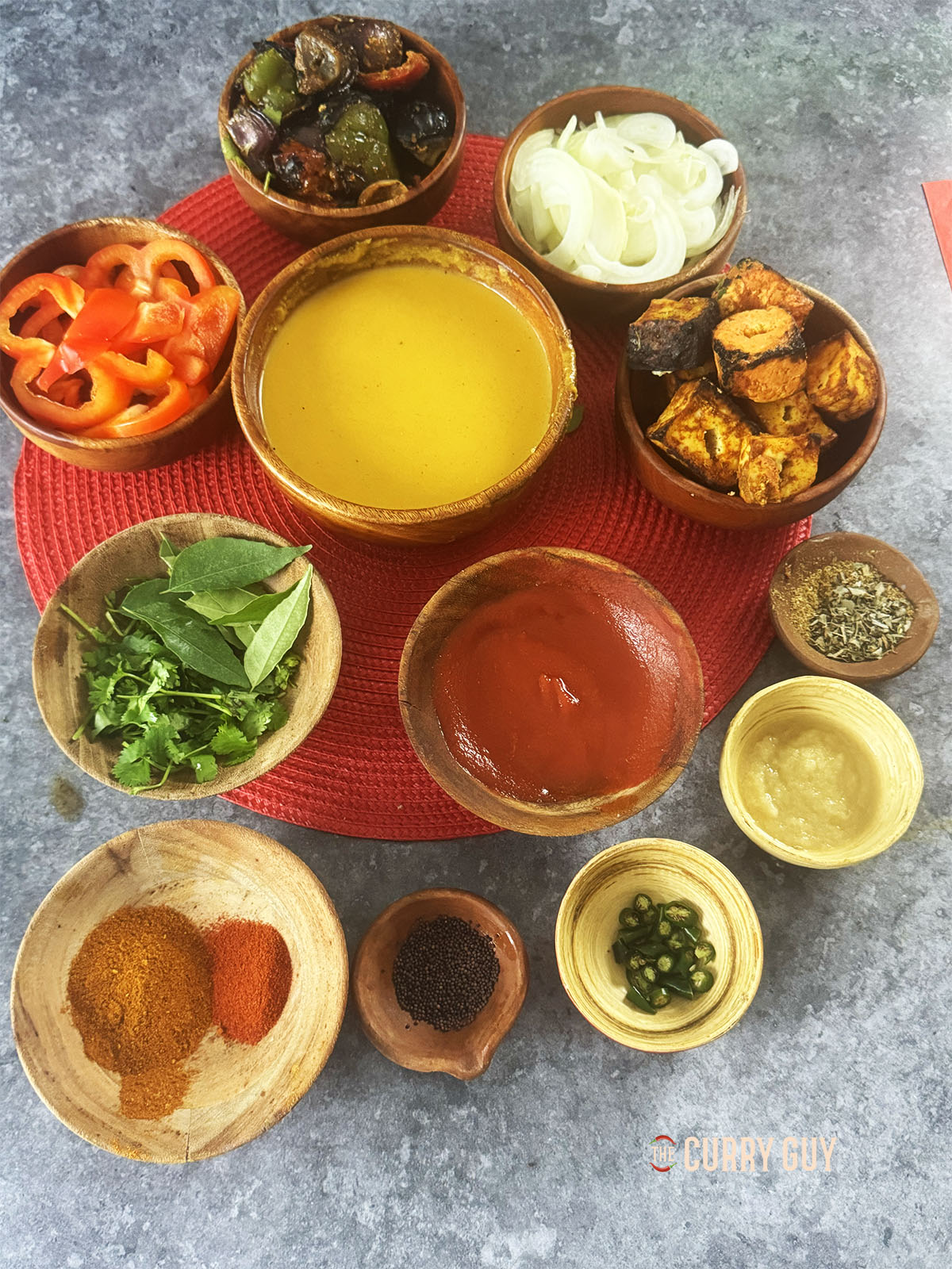 The ingredients for the recipe laid out on a counter ready to use in the curry.