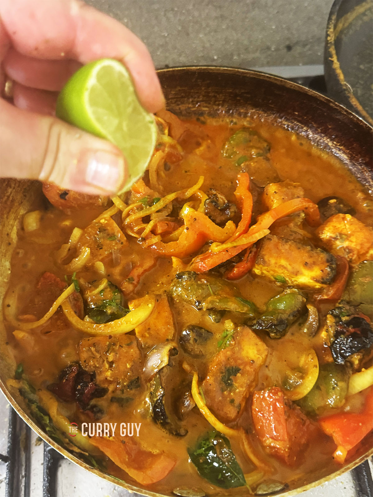 Squeezing lime juice to taste into the sauce.