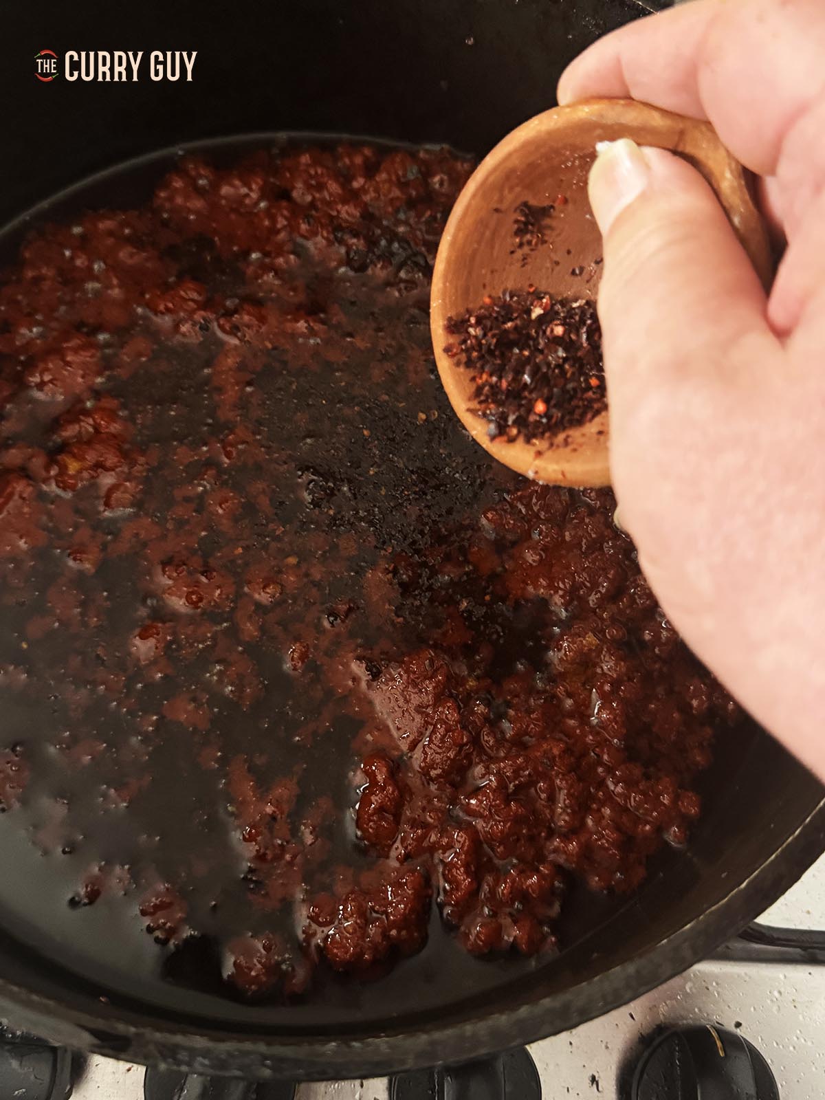 The red pepper sauce, simmering. Adding the Aleppo chilli flakes to the sauce.