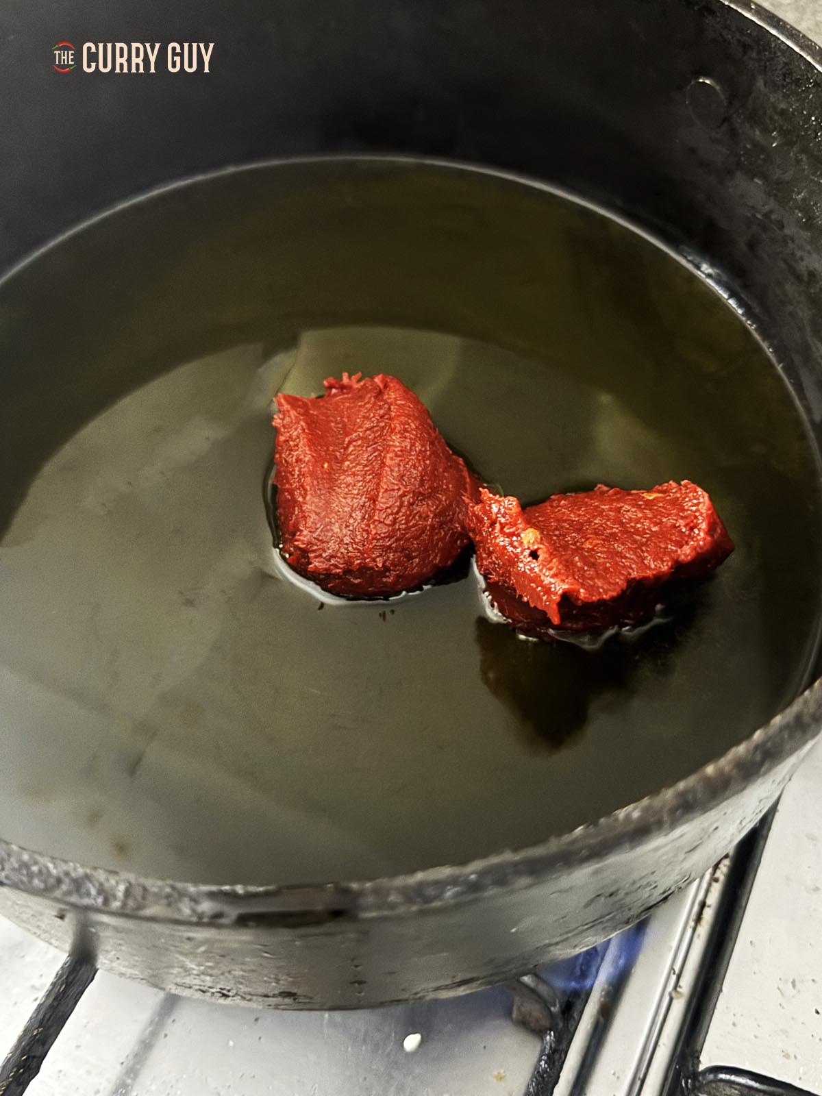 Preparing the red pepper sauce in a pan.