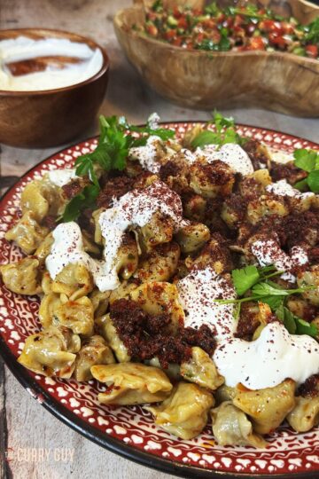 Turkish dumplings with sauces using this manti recipe. On a serving plate.