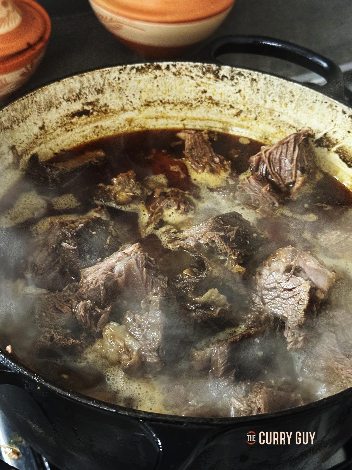 The meat being added back to the pan.