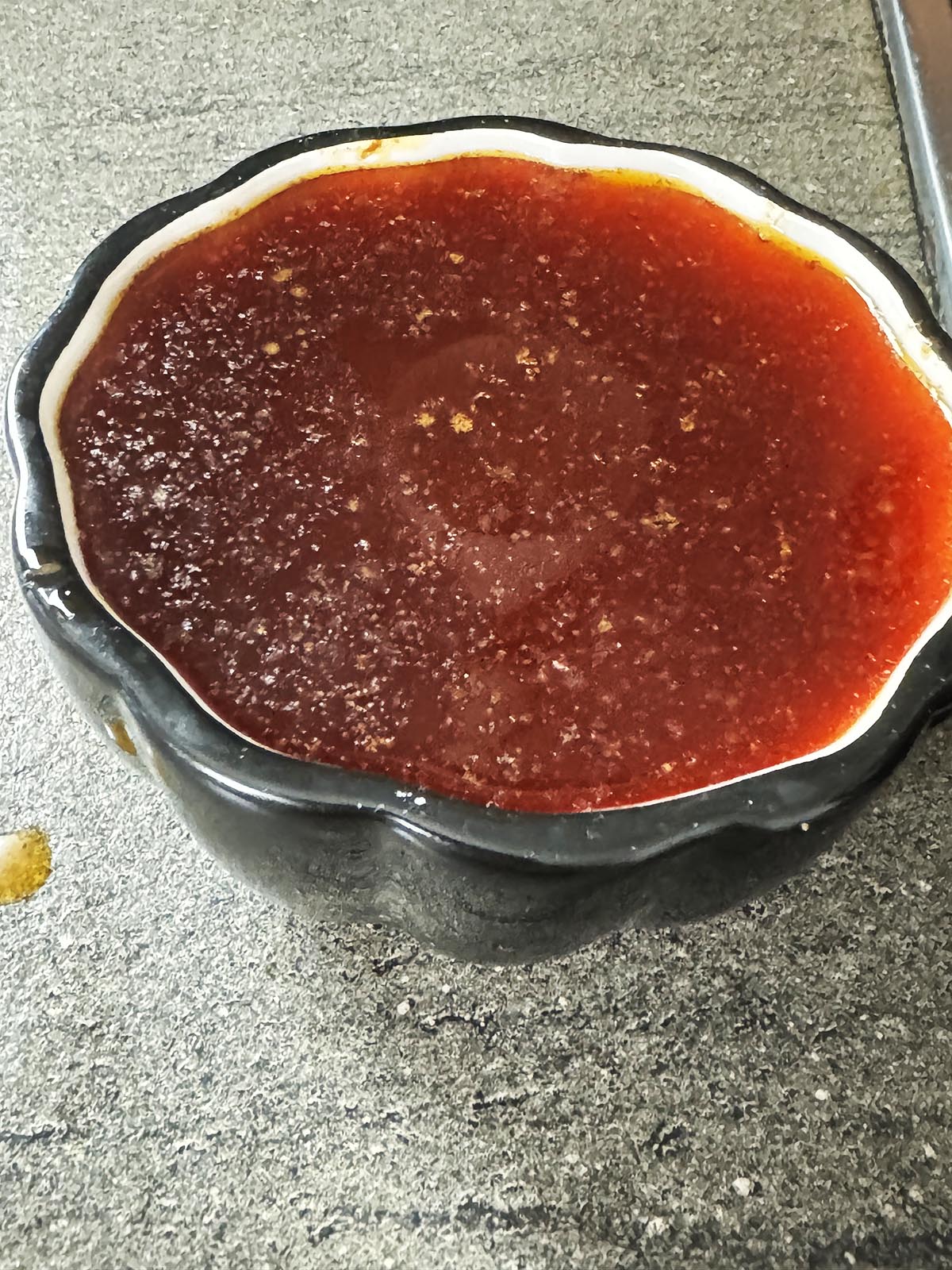 A bowl of liquid fat from the curry.