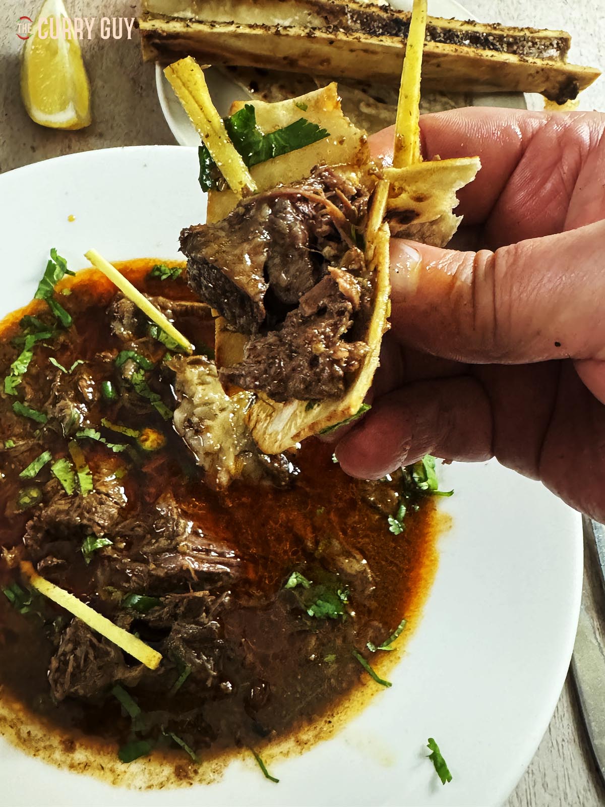 Some of the meat picked up in a paratha to eat.