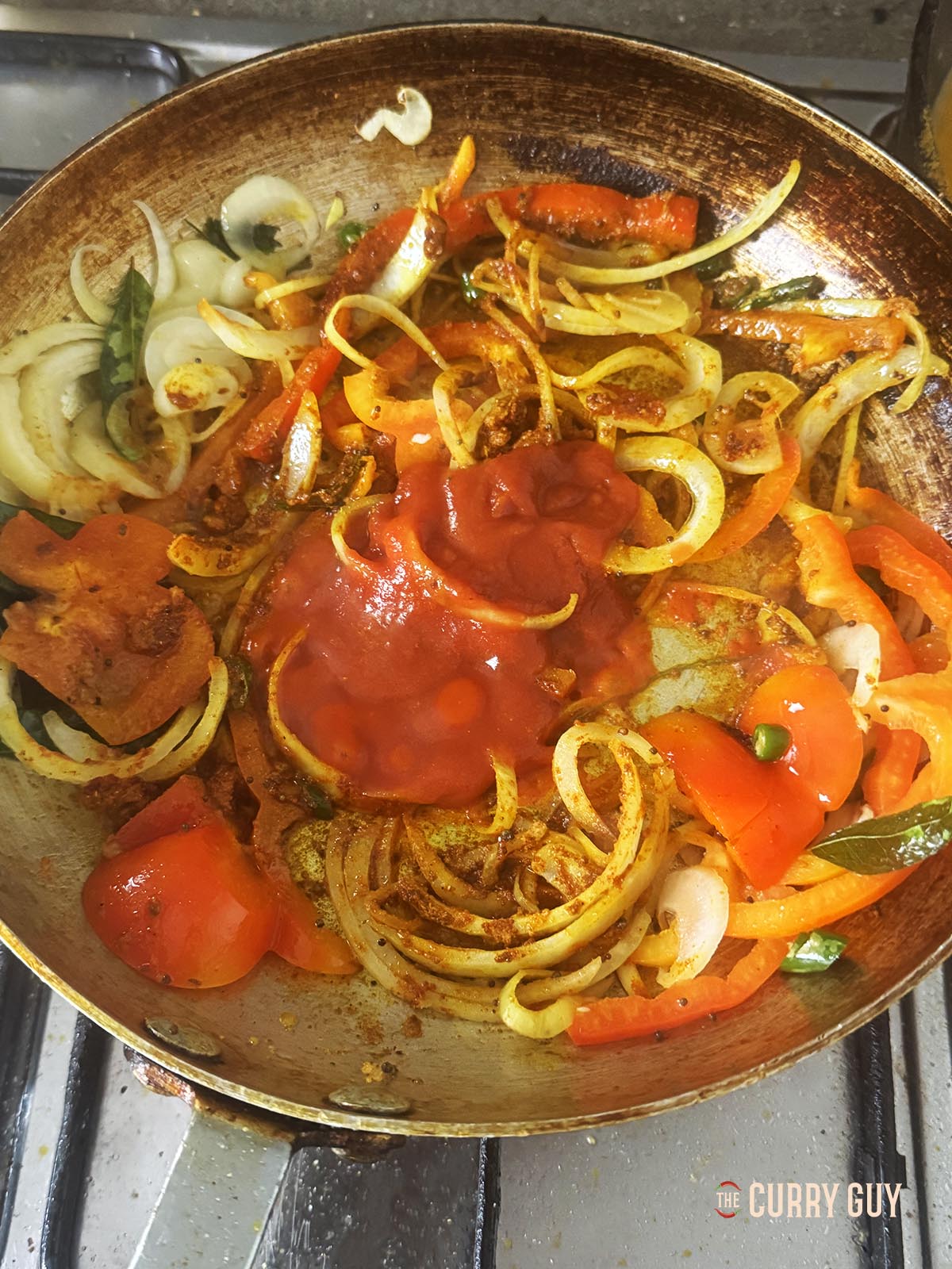 Adding the passat to the pan to give it some colour and moisture.