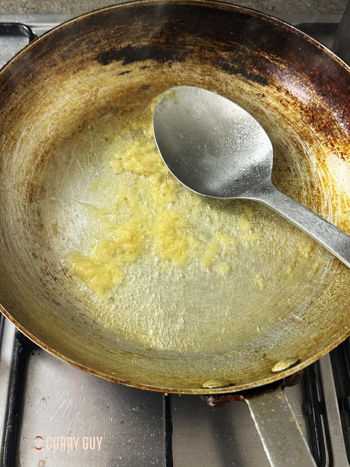 Adding the garlic and ginger paste and frying for 30 seconds.