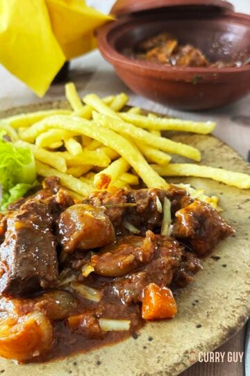 beef stifado served with french fries.