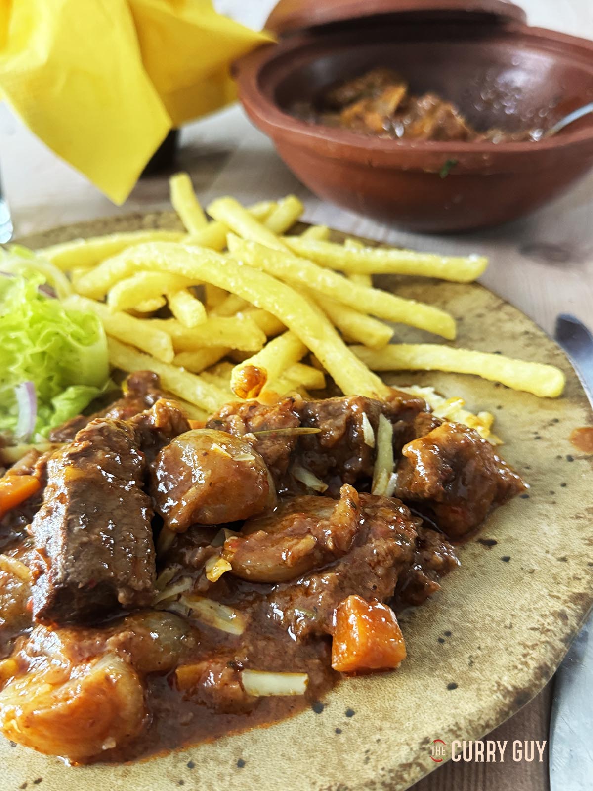 beef stifado served with french fries.