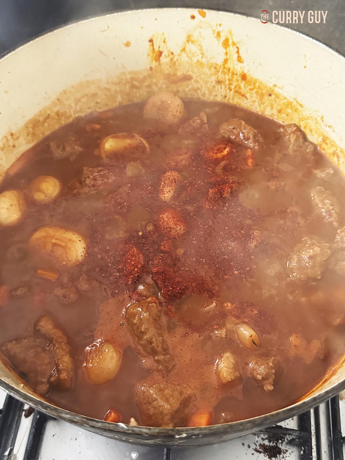 Simmering the sauce to thicken it.