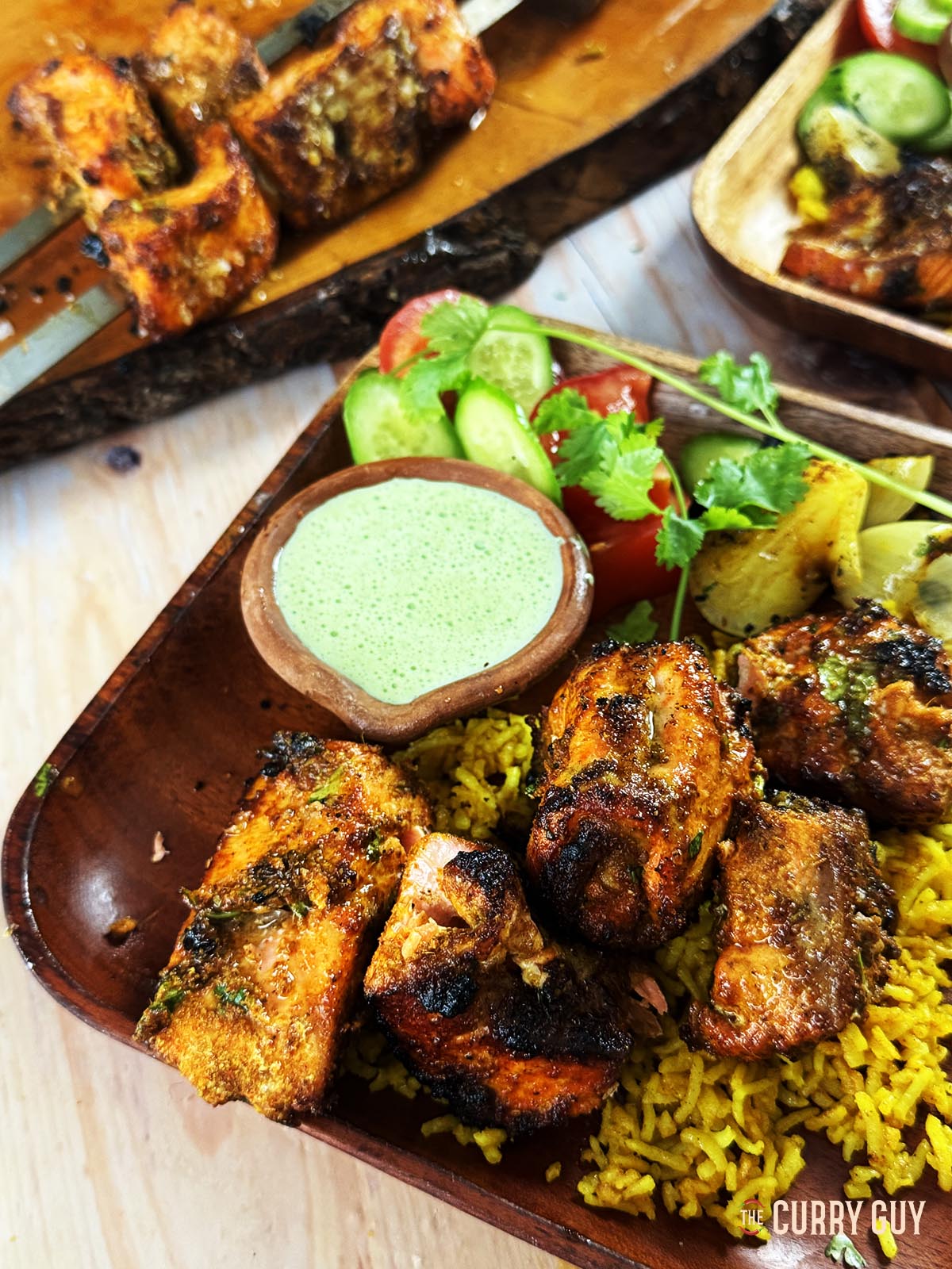 Tandoori salmon tikka on a bed of pilau rice. Served with a coriander and chilli sauce.