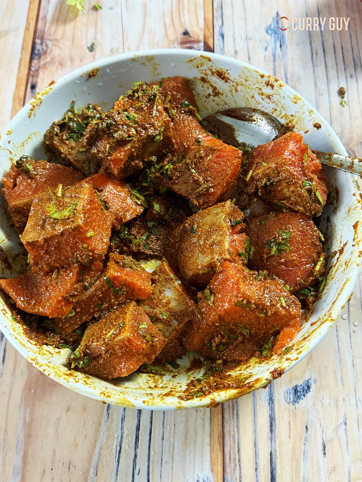 Marinating the salmon in a mixing bowl.