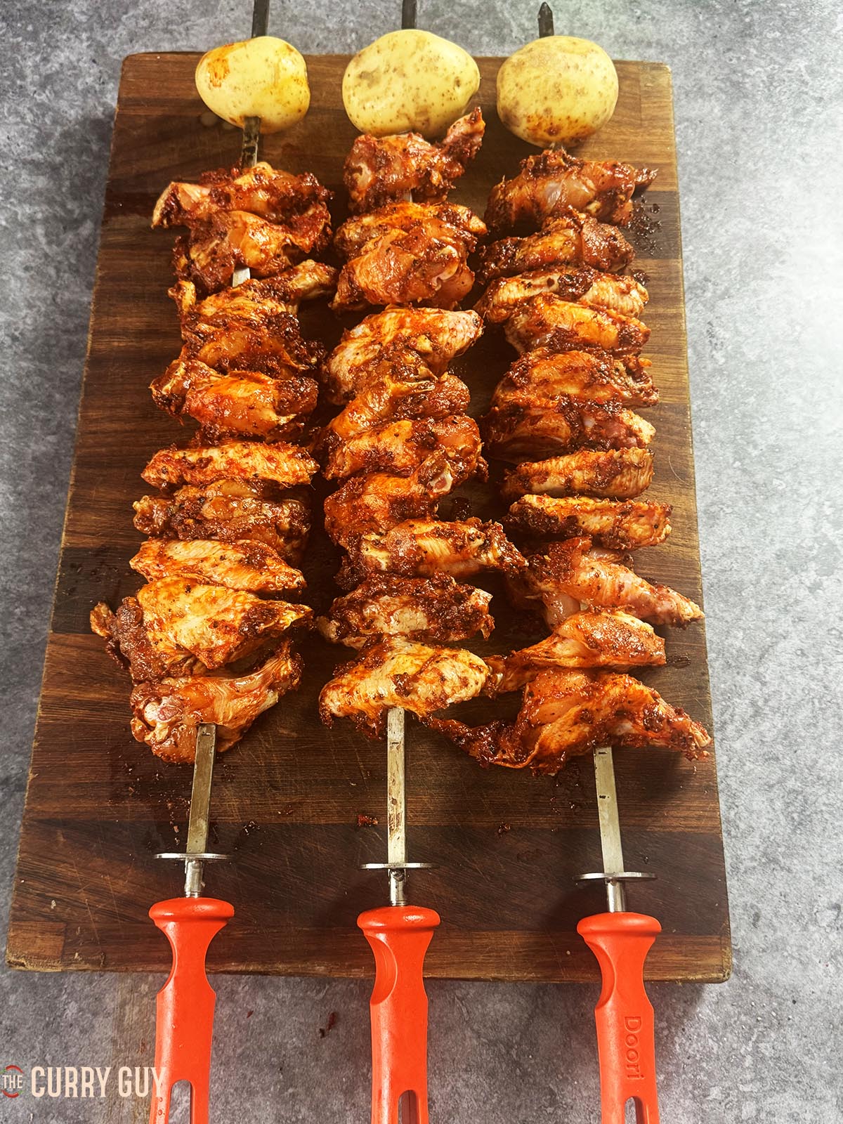 The chicken wings skewered and ready to cook.