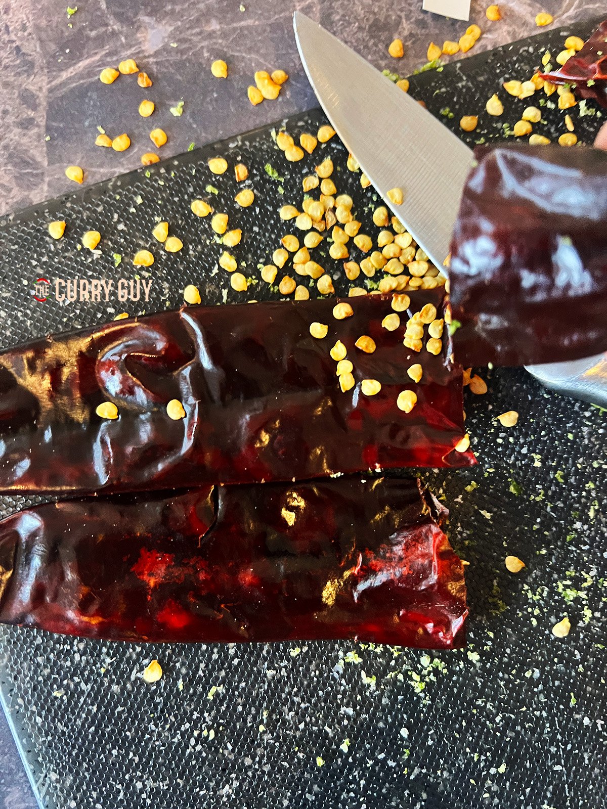 Removing the seeds from the chillies. 