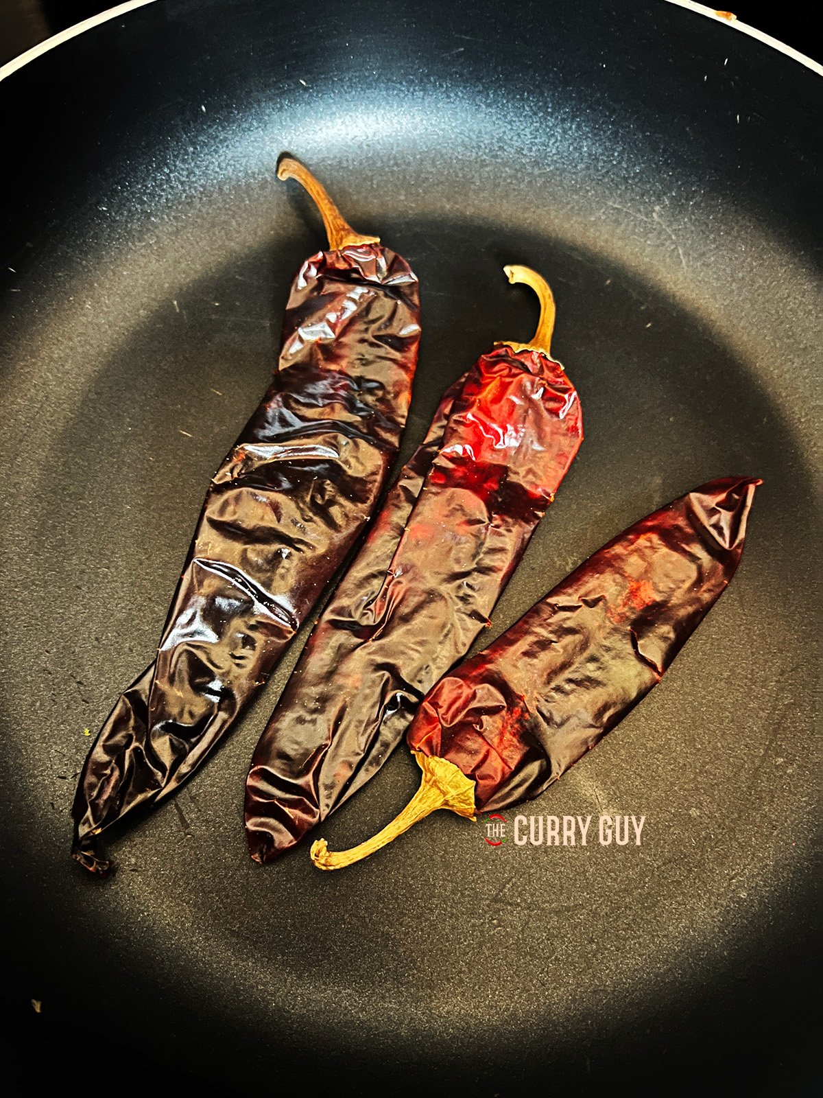 Toasting the dried chillies until fragrant.