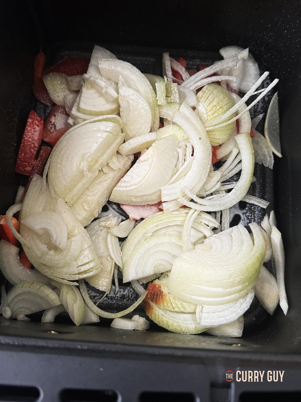 Adding the onions, bell pepper with oil and salt to the cooking basket.