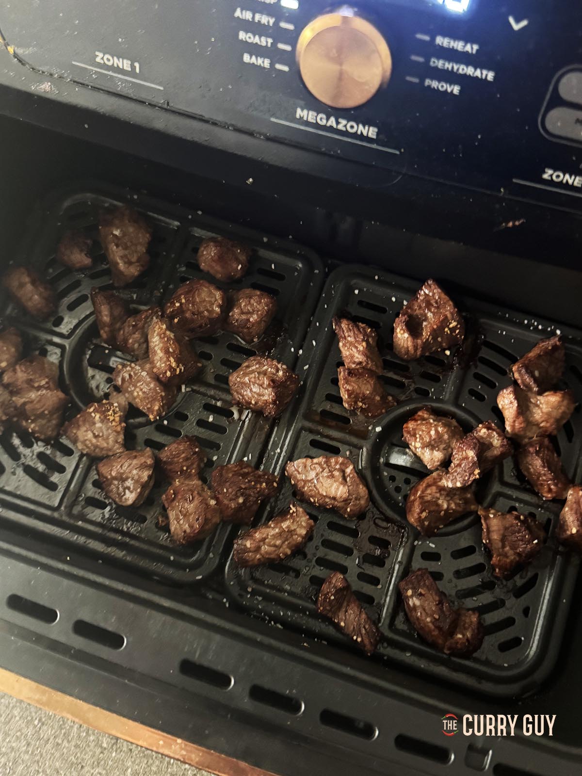 The beef cooking in the air fryer.