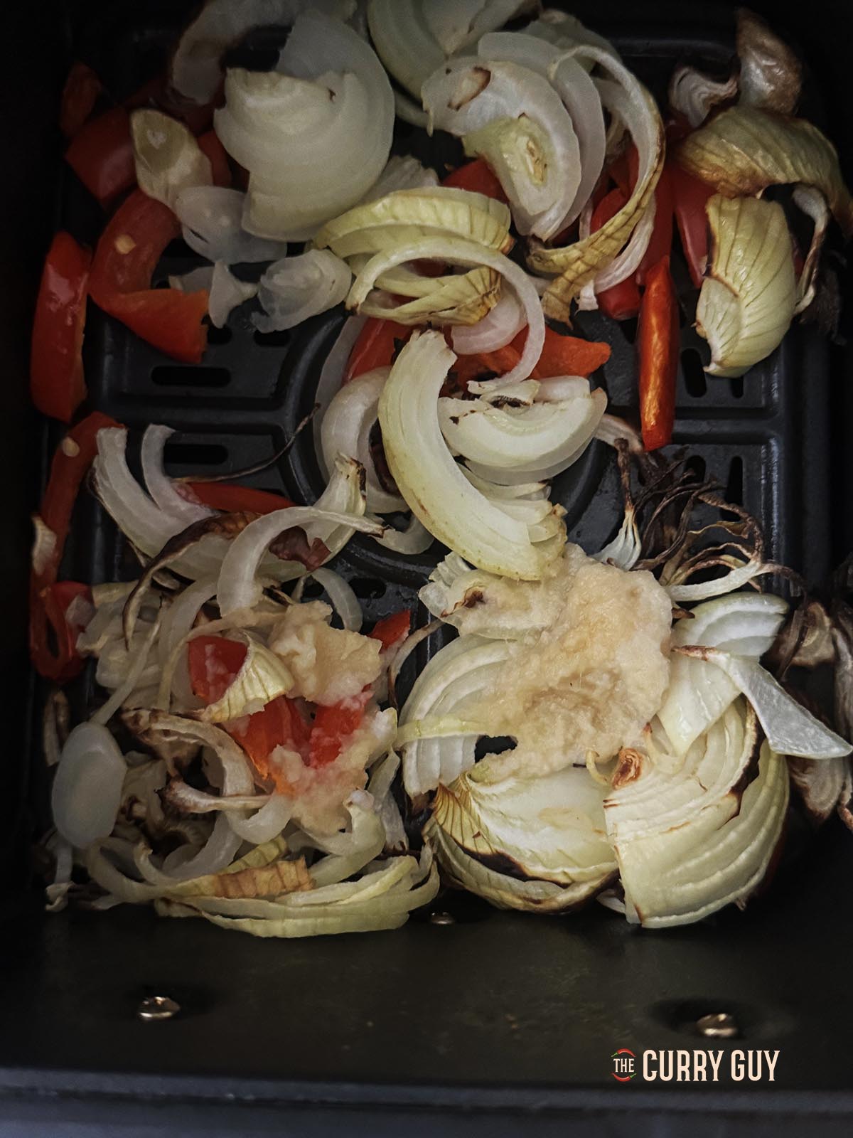 Adding the garlic and ginger paste to the basket.