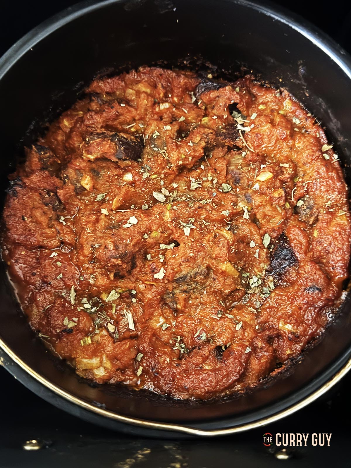 Adding garam masala and kasoori methi to the curry in the pan.